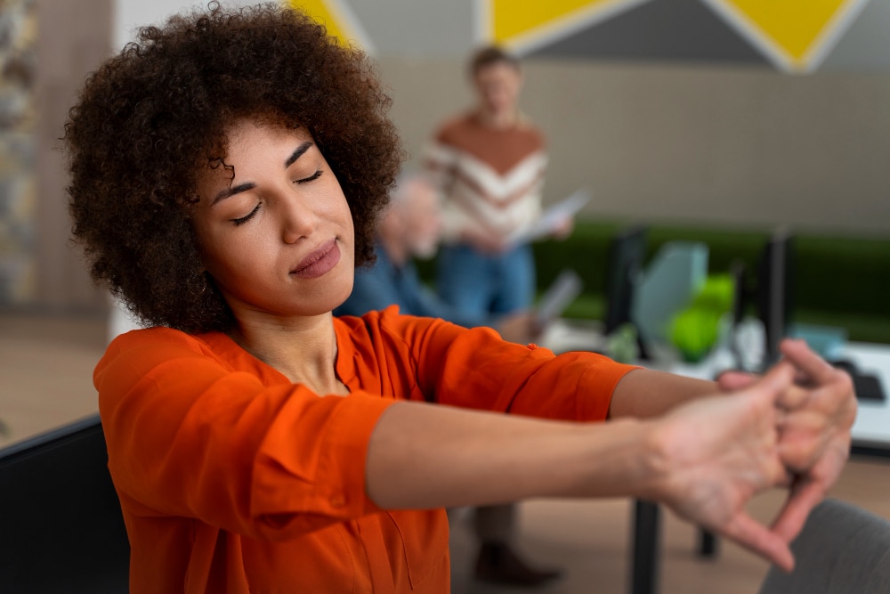 Woman at the office stretching during a work day