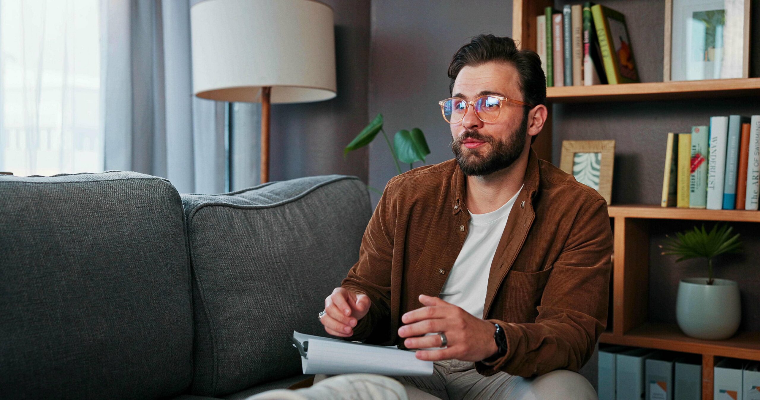 Male therapist taking notes during an individual counseling session at a men's addiction treatment center in Nashville Wellness.