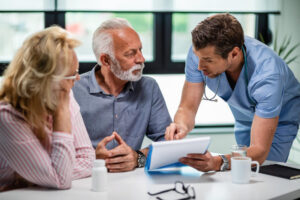 Doctor discussing medical records with a senior couple during prescription drug rehab in Nashville at Nashville Wellness.