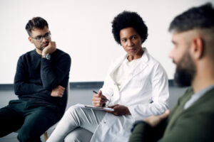 Psychotherapist leading a group therapy session during cocaine addiction treatment in Nashville, TN at Nashville Wellness.