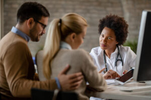 Doctor reviewing electronic medical records with a couple during prescription drug addiction rehab at Nashville Wellness.