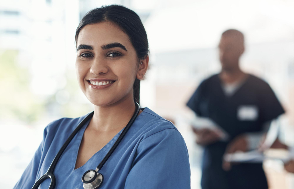 Surgeon and female healthcare professional smiling together in a hospital setting in Nashville, TN.
