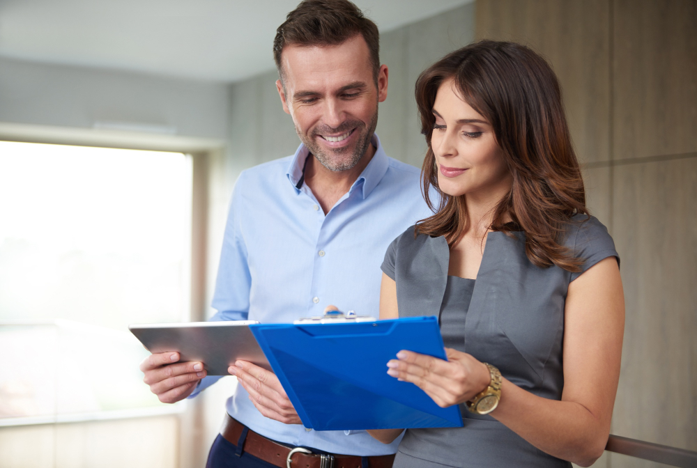 Man and woman reviewing insurance documents for rehab coverage.